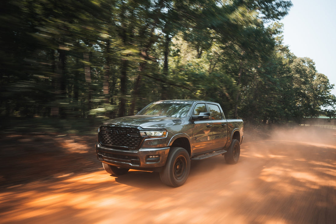 Rocky Ridge Ram barrels down a dirt road  kicking up dust