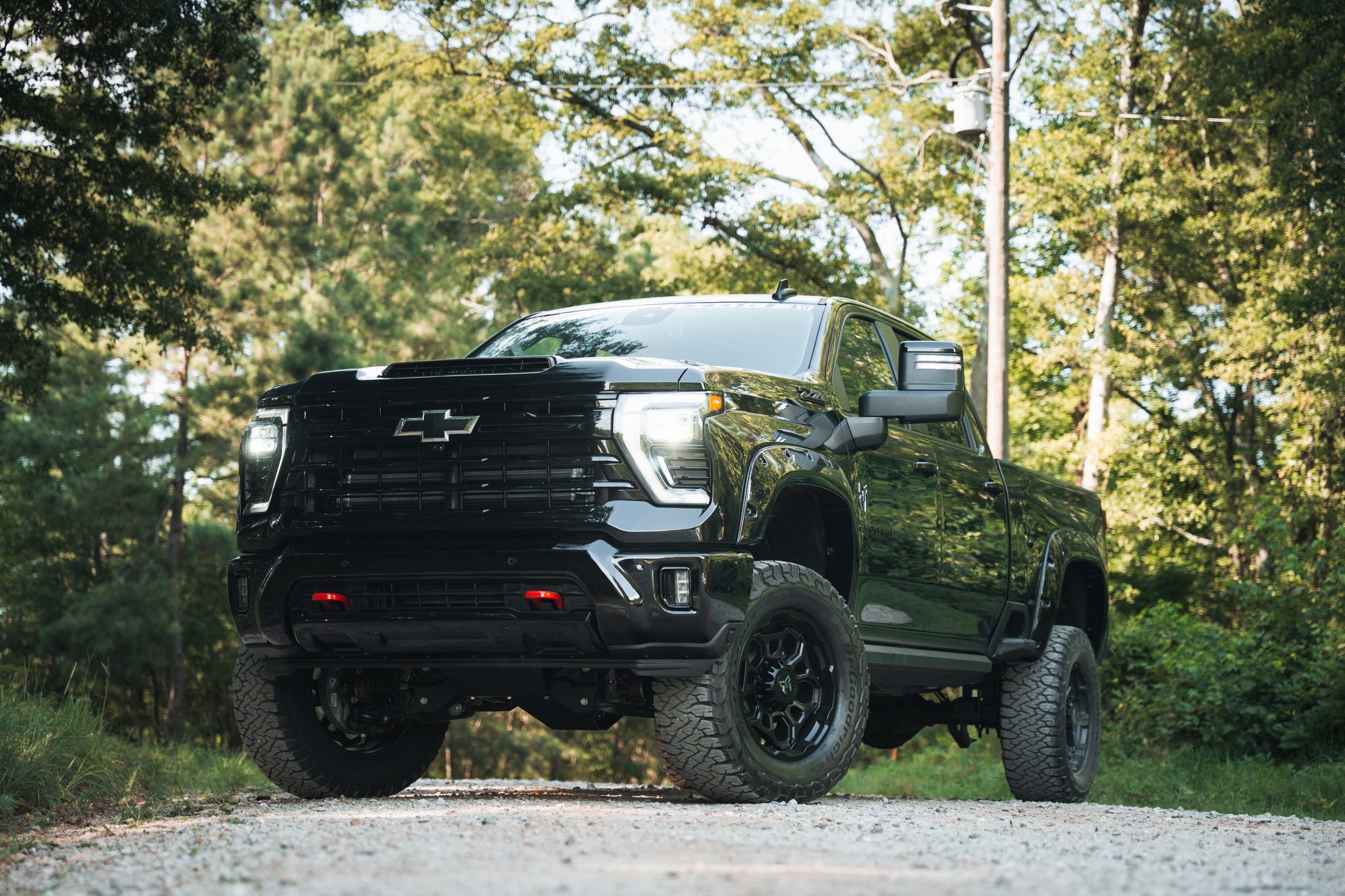 Rocky Ridge Silverado 2500 HD Lifted quarter view parked on a gravel road