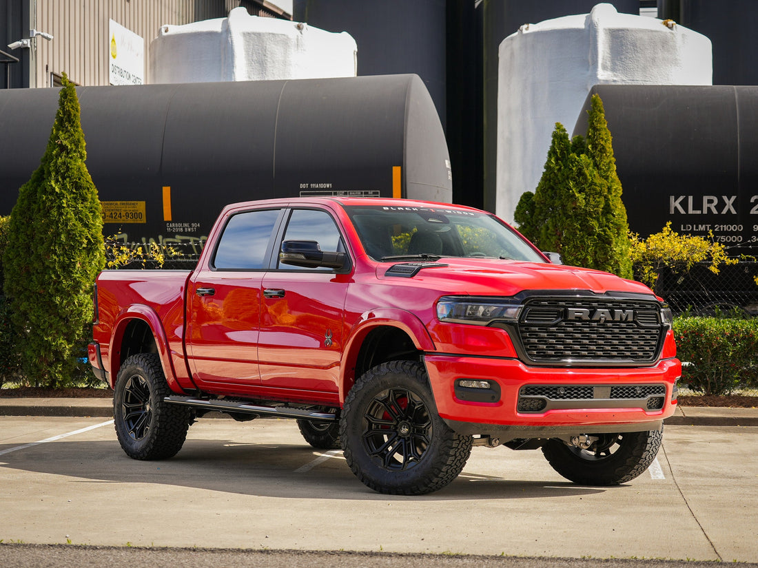 Red Black Widow Ram parked in an industrial scene.