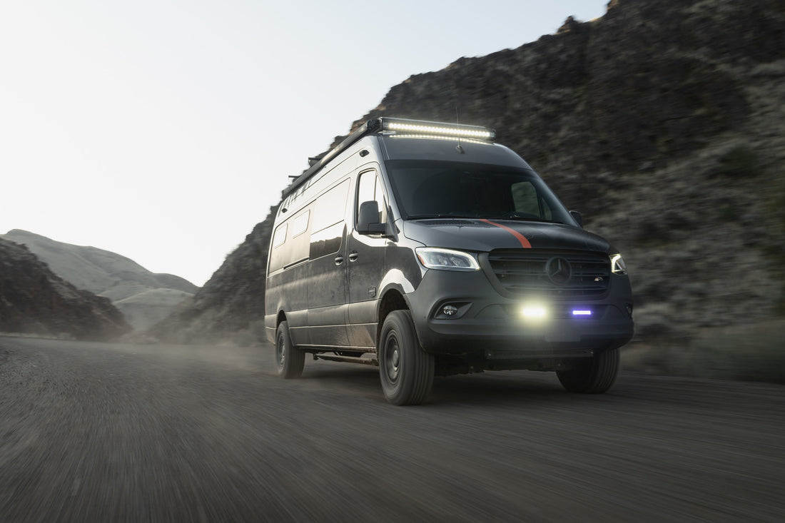 Outside Van sprinter van driving through a mountain pass on a dirt road