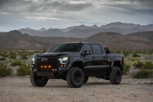 Fox Factory Silverado parked in the desert in a mountain scene.