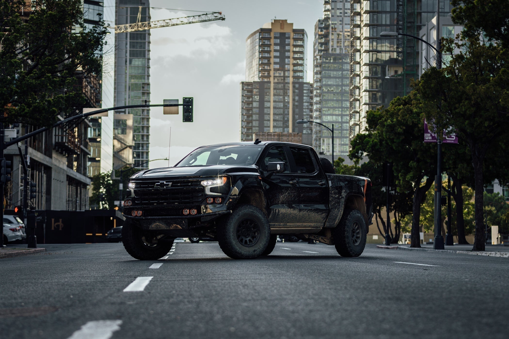 Fox Factory Silverado in a cityscape scene parked diagonally across a street.